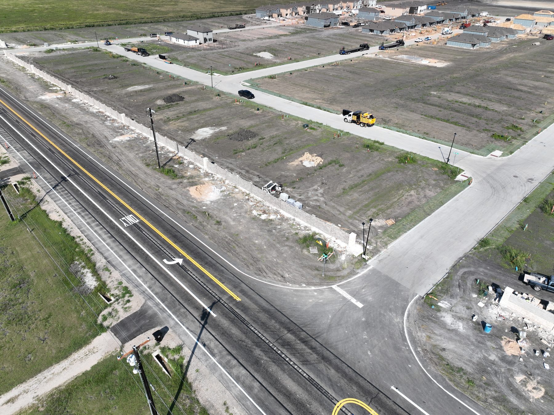 Aerial view of finished streets and delivered homesites at Cartwright Mays Phase 1 in Crandall, Texas, with homes under construction beyond