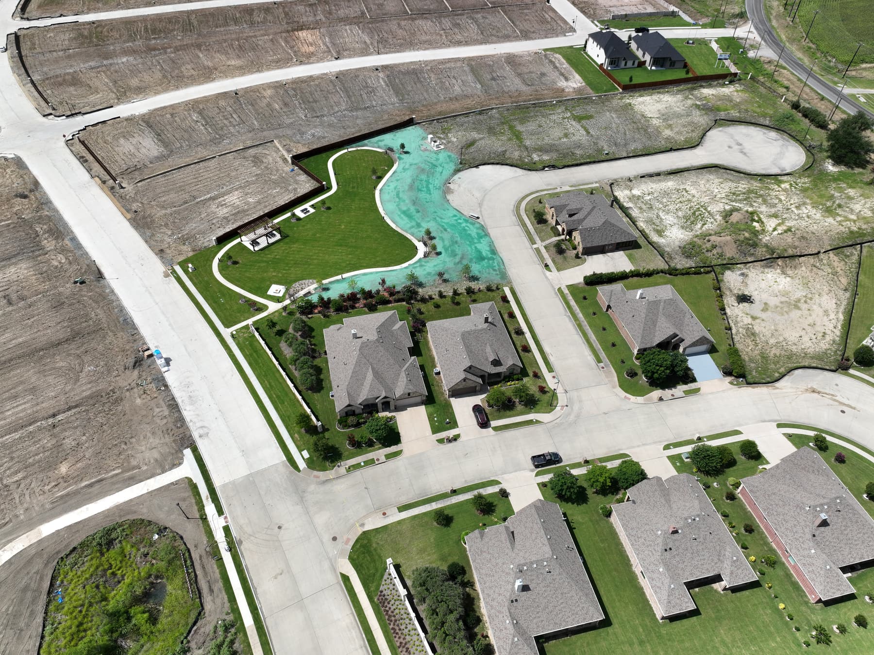 Aerial view of the completed amenity center and pool at Clearview Ranch in Royse City, Texas, with finished homes alongside