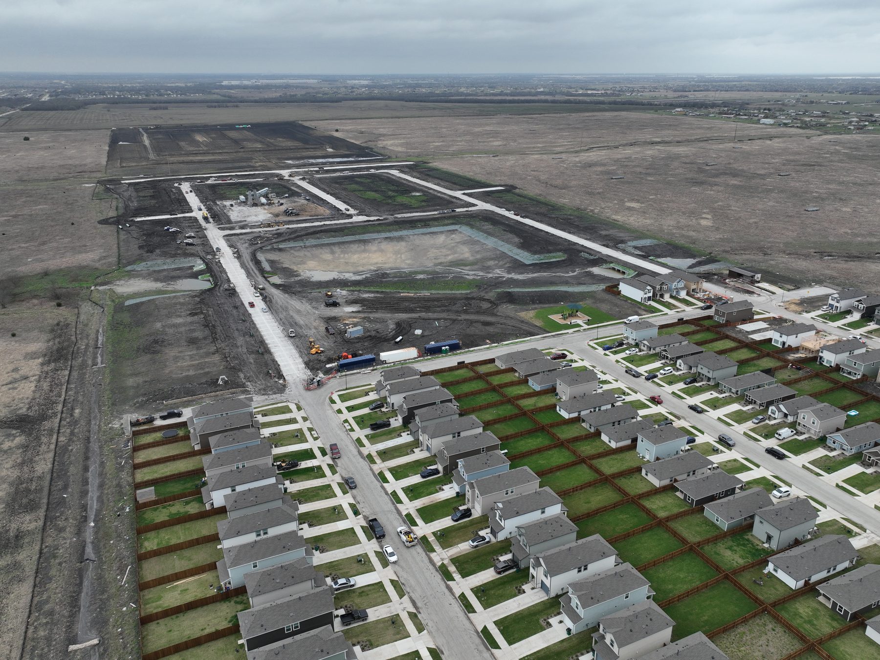 Aerial view of completed homes with finished lawns lining the streets of Cartwright Mays Phase 1 in Crandall, Texas