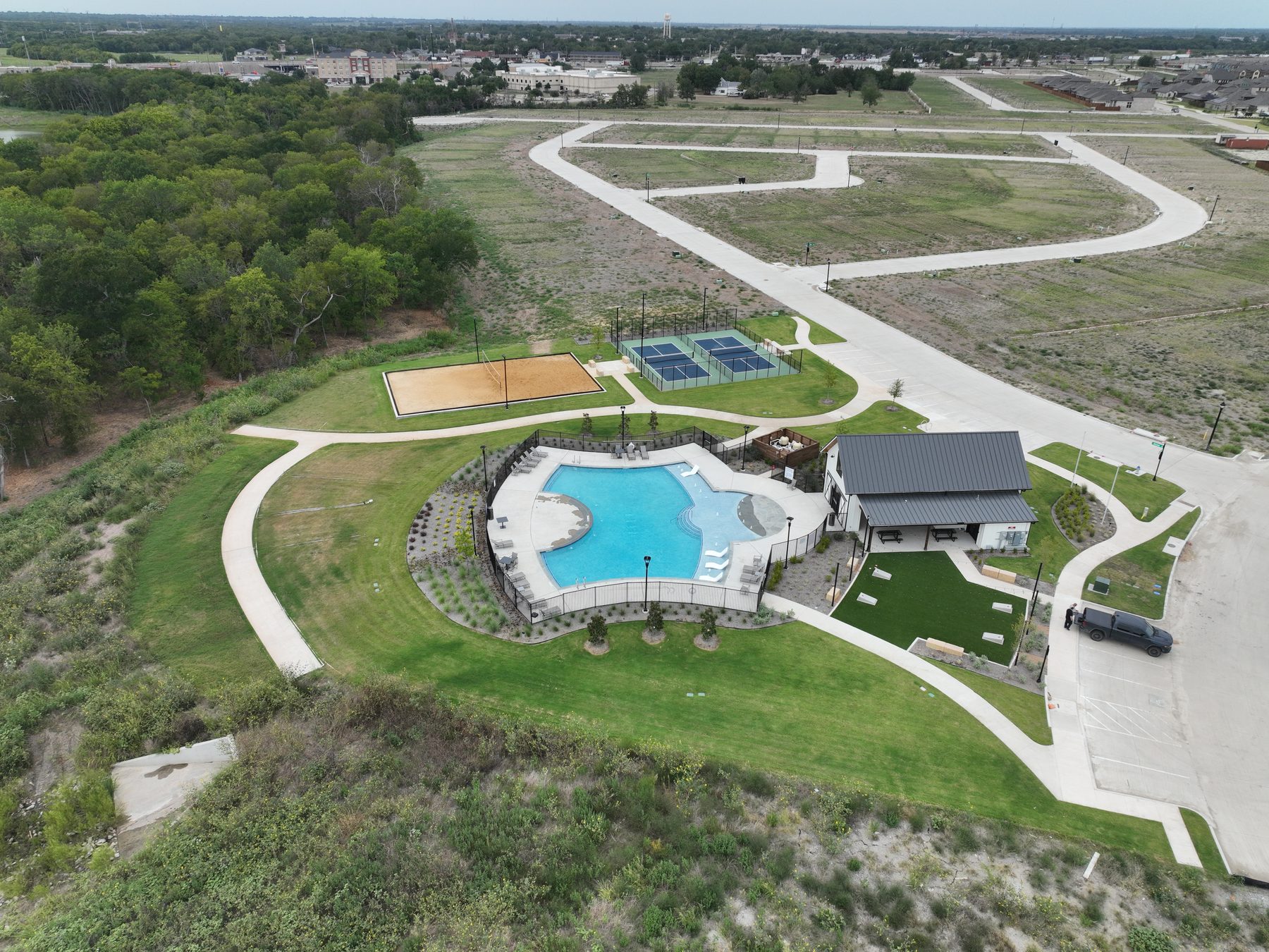 Aerial view of the amenity center at Liberty Crossing Phase 2 in Royse City, Texas, with pool, pickleball courts, and sand volleyball