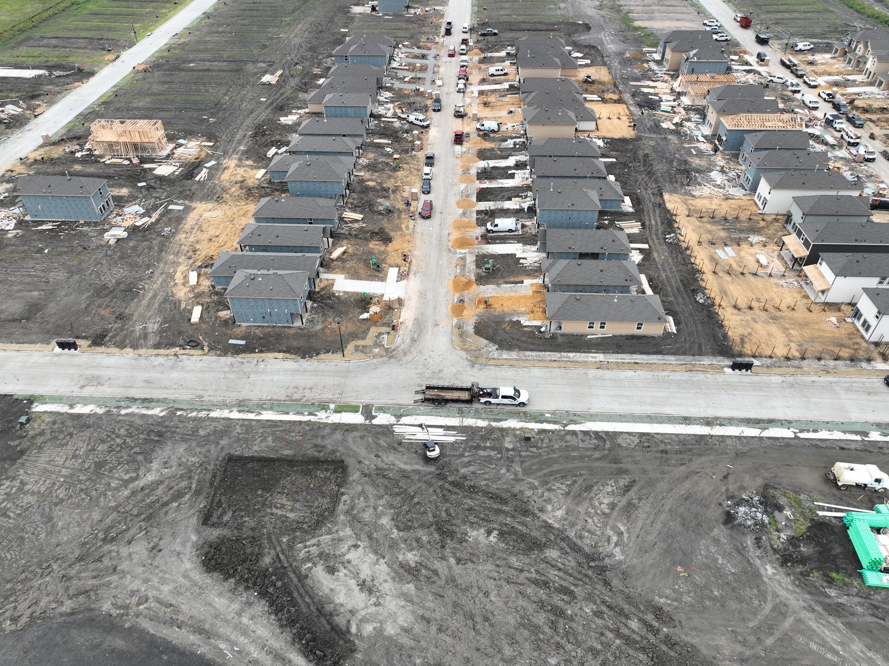 Aerial view of a homebuilder framing houses on finished lots at Cartwright Mays Phase 1 in Crandall, Texas, with lumber packages staged on the pads