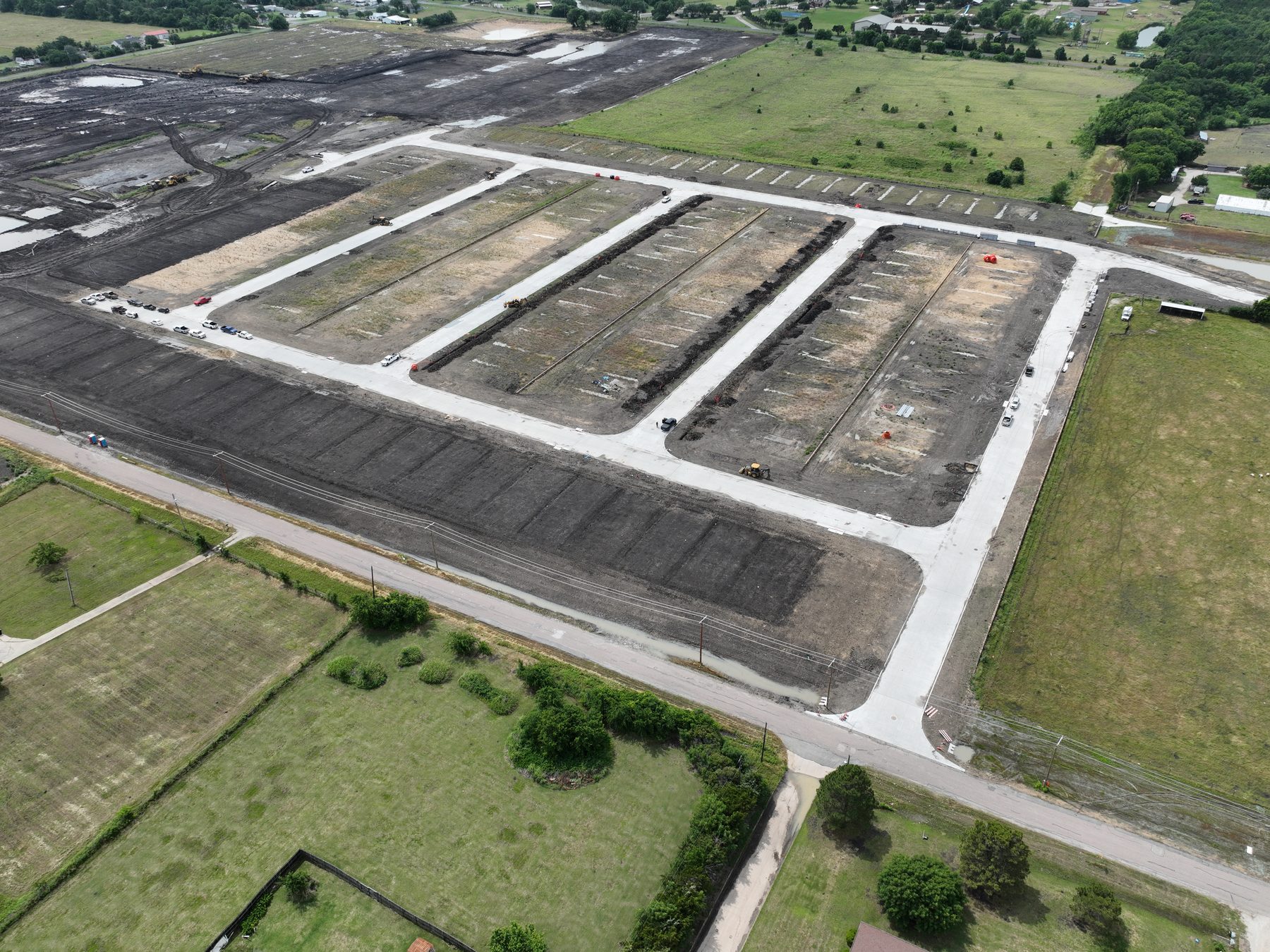 Aerial view of graded homesites and new street paving at Arbor Lakes Phase 1A near Princeton, Texas