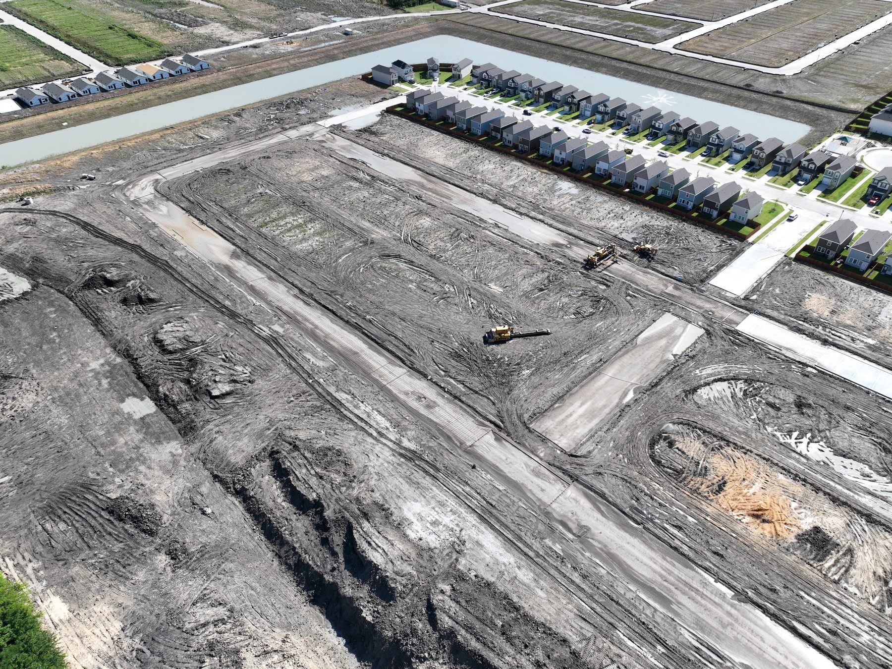 Aerial view of completed homes beside newly graded homesites at Arbor Trails Phase 2 in Princeton, Texas
