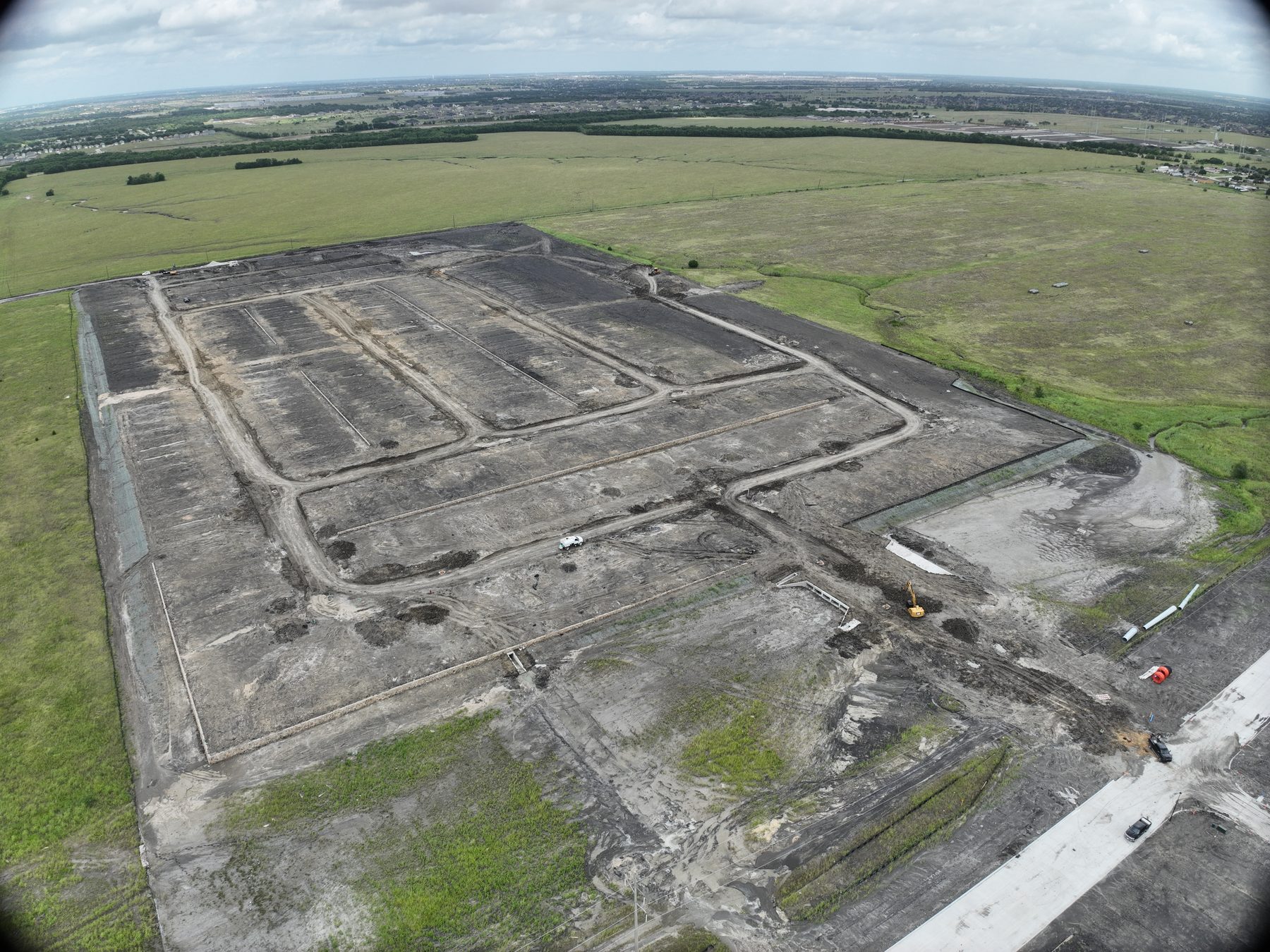 Aerial view of graded ground and street cuts across the Cartwright Mays Phase 3B site in Crandall, Texas