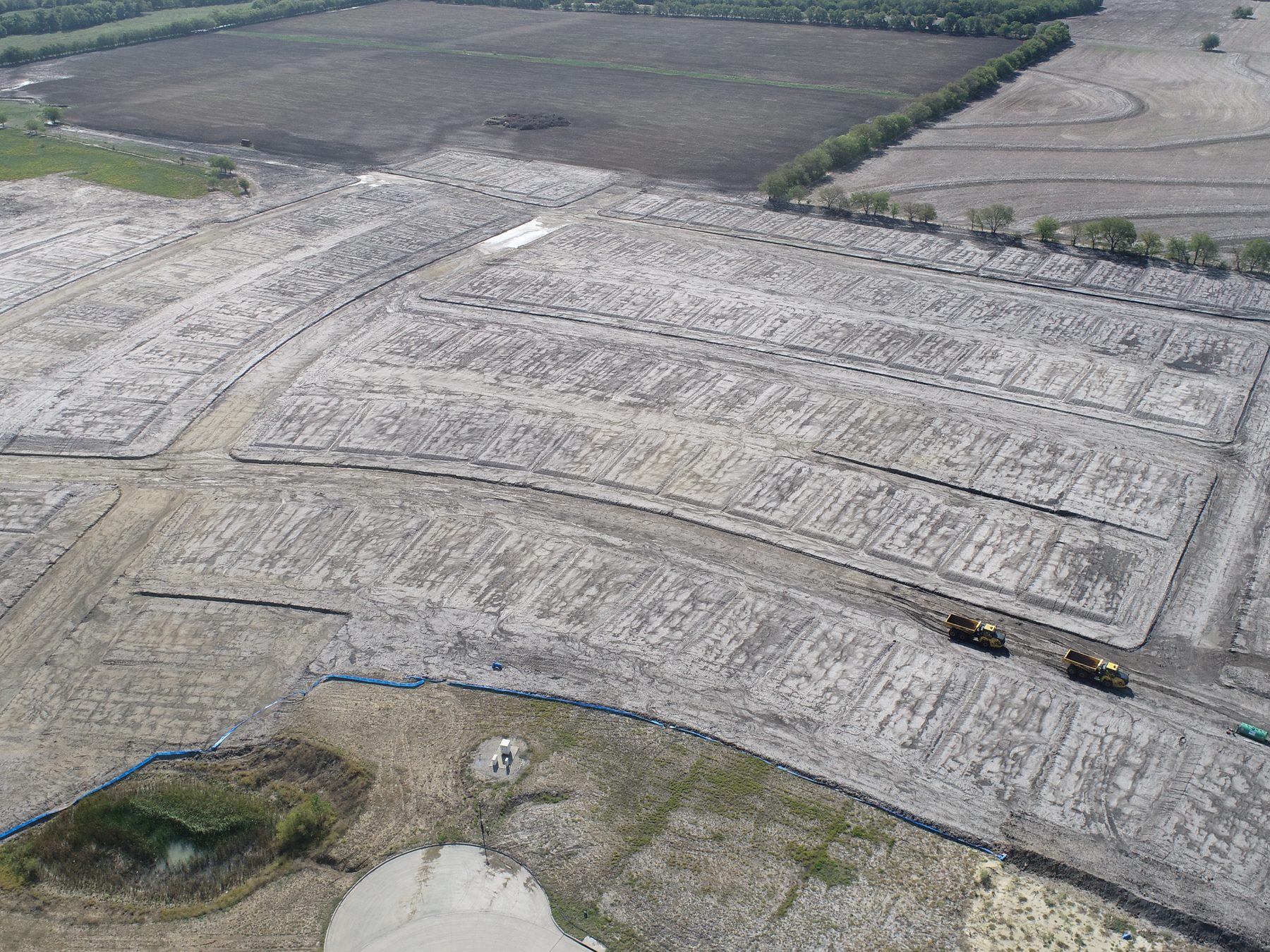 Aerial view of graded homesites and street subgrade under construction at Clearview Ranch Phase 1 in Royse City, Texas, with equipment working the site