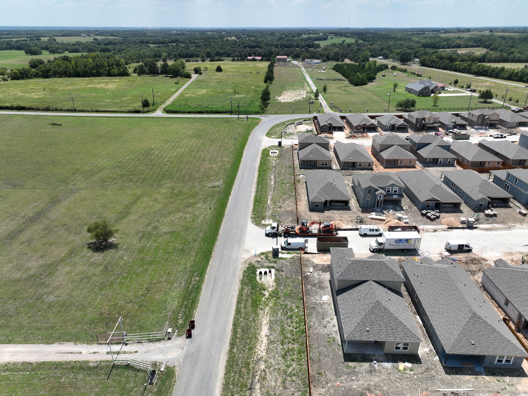 Aerial view of a built-out block of homes at Sweetwater Springs in Sherman, Texas, with the surrounding Grayson County countryside beyond